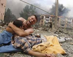 Pictures of the decade: A Georgian man mourns after Russian plane bombed an apartment block in Gori