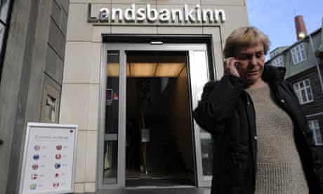 A woman leaves a branch of Iceland's second largest bank, Landsbanki