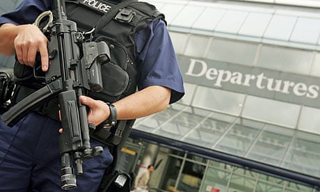 Police officer patrols Heathrow airport where an alleged bomb threat was made on an Emirates flight 