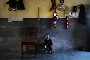 Khagendra Thapa Magar: Khagendra Thapa Magar sits on a small stool inside his home