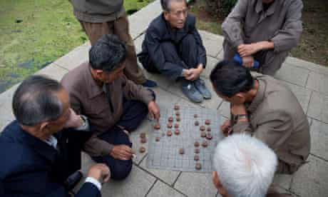 Old men play Korean Chess near the Party Foundation Monunment in Pyongyang.