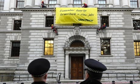 Greenpeace protesters erect a banner at the Treasury