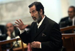 A Day in Iraq: Ousted Iraqi leader Saddam Hussein gestures during his trial in Baghdad
