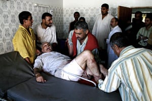 A Day in Iraq: A wounded Iraqi elderly is rushed into a hospital in Baquba