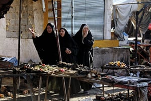 A Day in Iraq: Iraqi women weep at the scene of destruction at a popular market