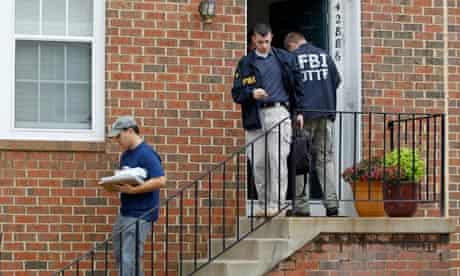 FBI agents leaving the home of Farooque Ahmed in Ashburn, Virginia