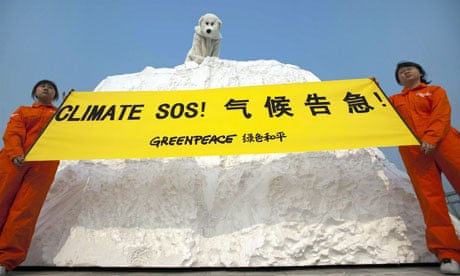 Greenpeace activists hold a banner outside the Tianjin climate talks