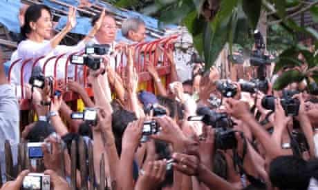 Burmese pro-democracy leader Aung San Suu Kyi greets supporters after her released from house arrest