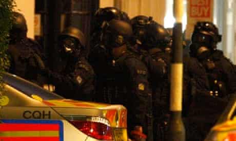 Armed police gather to end a stand-off with an armed man in King's Road, in west London