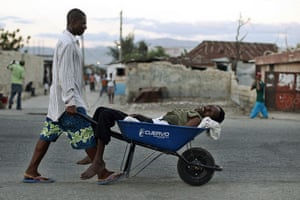 Haiti Cholera: A Haitian with symptoms of cholera  in a wheelbarrow in Port-au-Prince