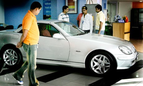 Young Indians inspect a Mercedes Benz
