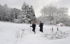 Weather Update: Walkers make their way through the snow in Dalby Forest, North Yorkshire