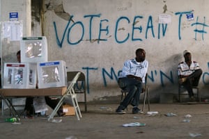 Haiti Elections: Poll workers sit idle next to ballot boxes
