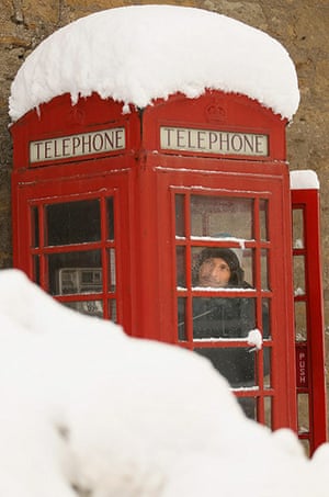 More Snow hits the UK: A man makes a call from a telephone box on in Dunning, Scotland