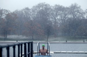 More Snow hits the UK: A swimmer climbs out of the freezing waters of the Serpentine Lido 