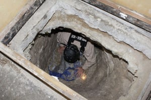 Tunnel Drug Smuggling: Federal agent crawls through a  tunnel found between USA and Mexico