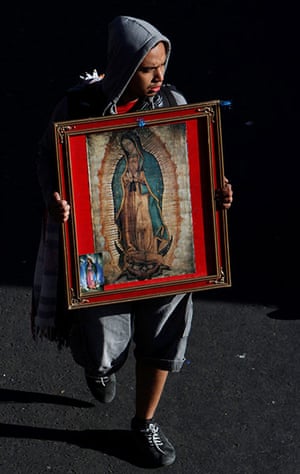 Guadalupe festival : A pilgrim carries an image of the Virgin of Guadalupe
