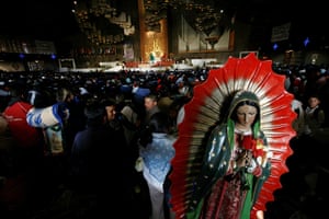 Guadalupe festival : A statue of the Virgin of Guadalupe sits on a pilgrim's back