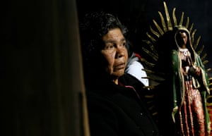 Guadalupe festival : A pilgrim holds a statue of the Virgin of Guadalupe
