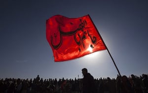 Ashura Religious Festival: Afghan Shi'ite Muslim boy holds a flag during a procession to mark Ashura