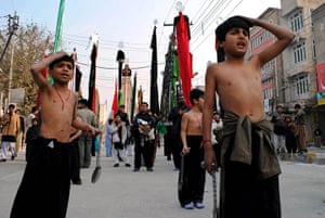 Ashura Religious Festival: Shi'ite muslim boys attend a mourning procession,  Peshawar, Pakistan