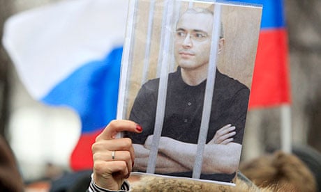 A woman holds a picture of jailed tycoon Mikhail Khodorkovsky at a rally in Moscow