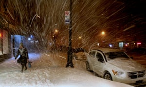 snow in US: A pedestrian walks along 72nd Street in New York