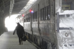 East coast blizzards: A train conductor makes his way to a train at the Hoboken Rail Terminal 