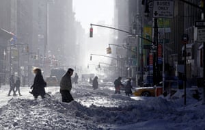 East coast blizzards: People walk through the snow on 7th Avenue in New York