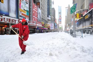 East coast blizzards: A worker shovels snow from Times Square in New York