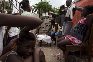 Haiti Cité Maxo: The Almeus family gathers at their tent in the camp settlement Cité Maxo