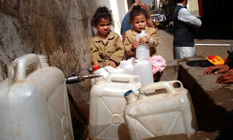 Yemeni children wait to fill their containers with drinking water in Sana'a