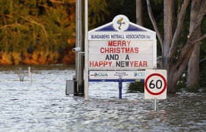 Queensland Flooding: Signboards are partially submerged by floodwater in Bundaberg
