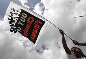 COP16 protest: An activist of Jubilee South holds a banner in Cancun