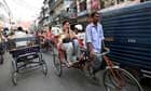 A woman travels in a rickshaw in New Delhi, India