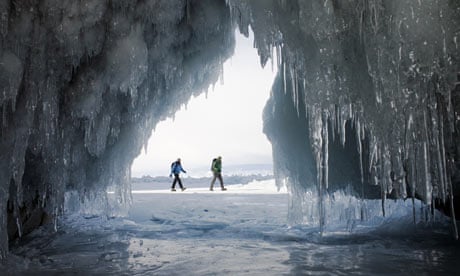 A couple of hikers on the frozen Lake Baikal in Siberia