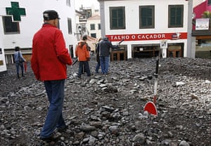 madeira: People walk over the debris in Funchal after heavy flooding in Madeira