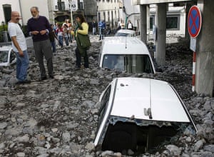 madeira: People look at cars buried under debris after flooding in Funchal, Madeira