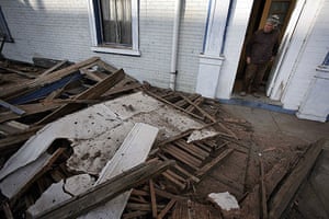 Chile Earthquake: A man looks at the debris outside his house in Valparaiso