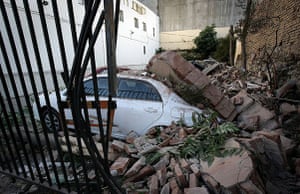 Chile Earthquake: A car is seen under a pile of rubble in Valparaiso