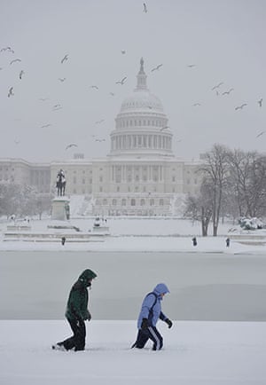 Washington in the snow: Walkers trudge through the snow in front of Congress