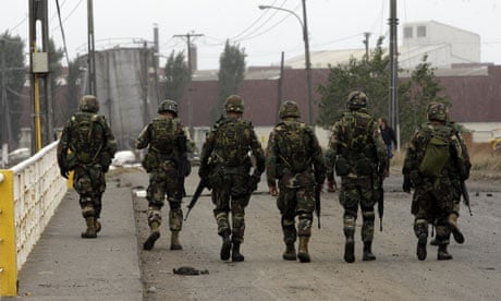 Soldiers guard the streets of Talcahuano, southern Chile, after an earthquake struck.