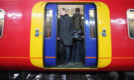 Commuters squeeze on to a train to Victoria Station