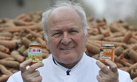 Claus Hipp with two jars of Hipp baby food at the company's German HQ