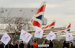 Ba strike 2: Striking British Airways cabin crew carry flags past BA aircraft