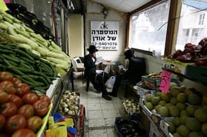 24 hours in pictures: Jerusalem: Ultra-Orthodox Jews sit in a food supply depot