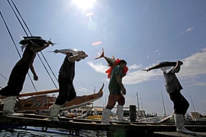 24 hours in pictures: General Santos, Philippines: Fishport workers carry tunas for processing