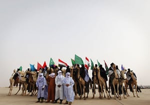 24 Hours in Pictures: Libyan camel riders with the flags of Arab countries perform
