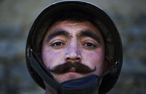 24 hours: A soldier stands guard in a village on the border of Afghanistan 