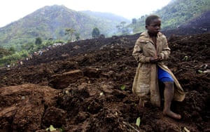 24 hours: A boy walks over soil after a landslide in Bududa, Uganda